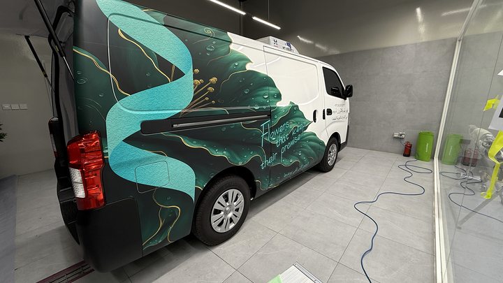 White Ever Bloom delivery van with dark green floral commercial graphics installed in Dubai