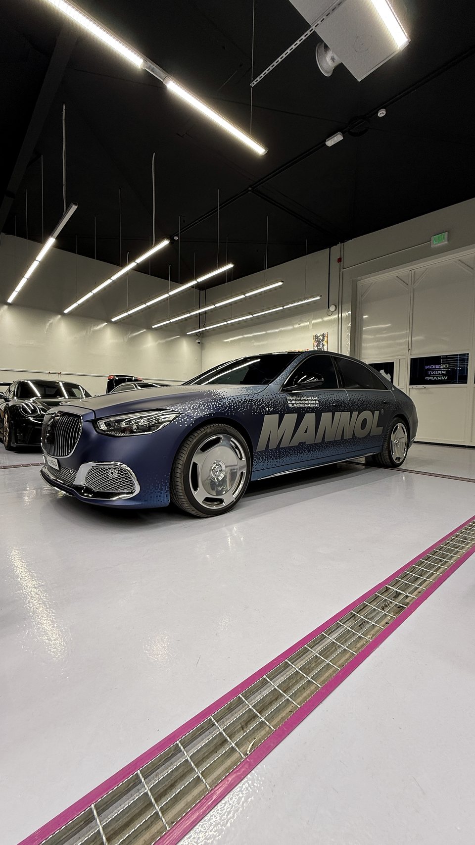 Blue MANNOL sedan with full commercial graphics photographed in the JUST GRAPHICS workshop