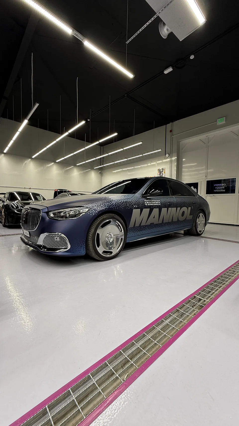 Blue MANNOL luxury sedan with full commercial graphics photographed in the JUST GRAPHICS workshop