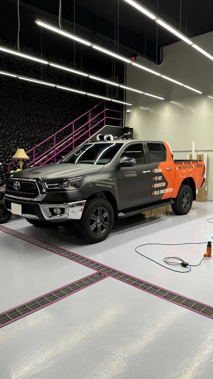 Grey pickup with orange partial commercial graphics