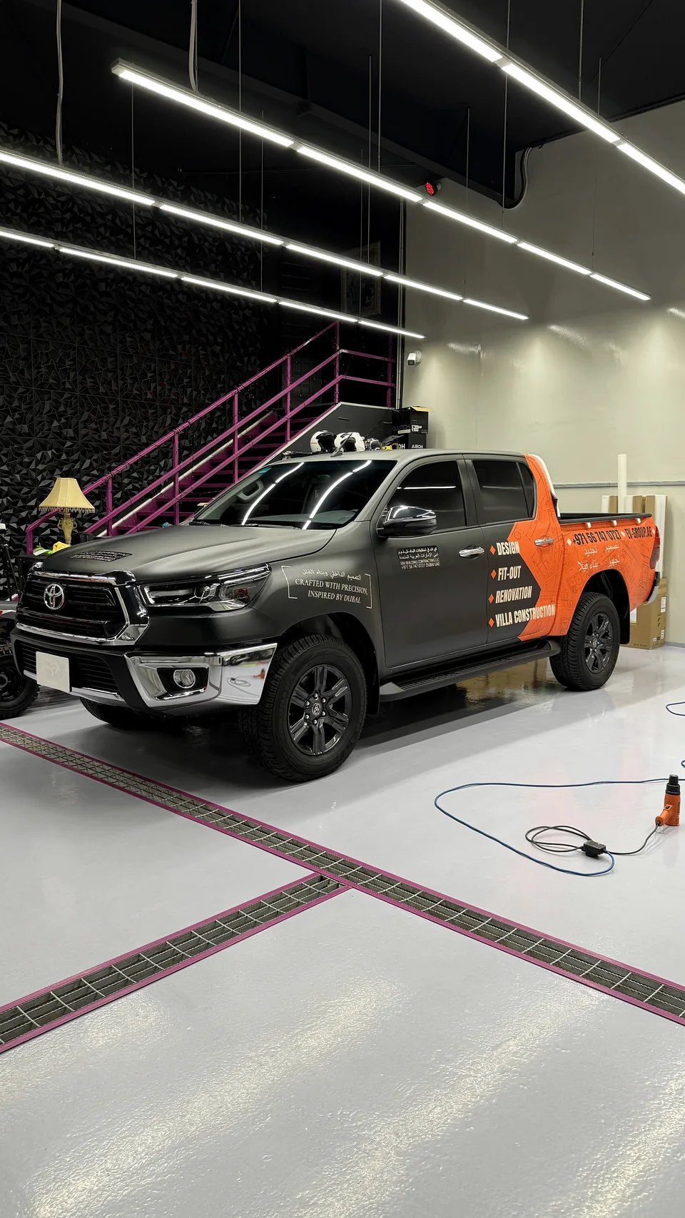 Grey and orange EV Group pickup with commercial branding installed in Dubai