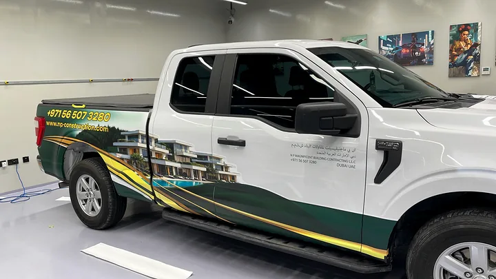White pickup with green and gold spot graphics