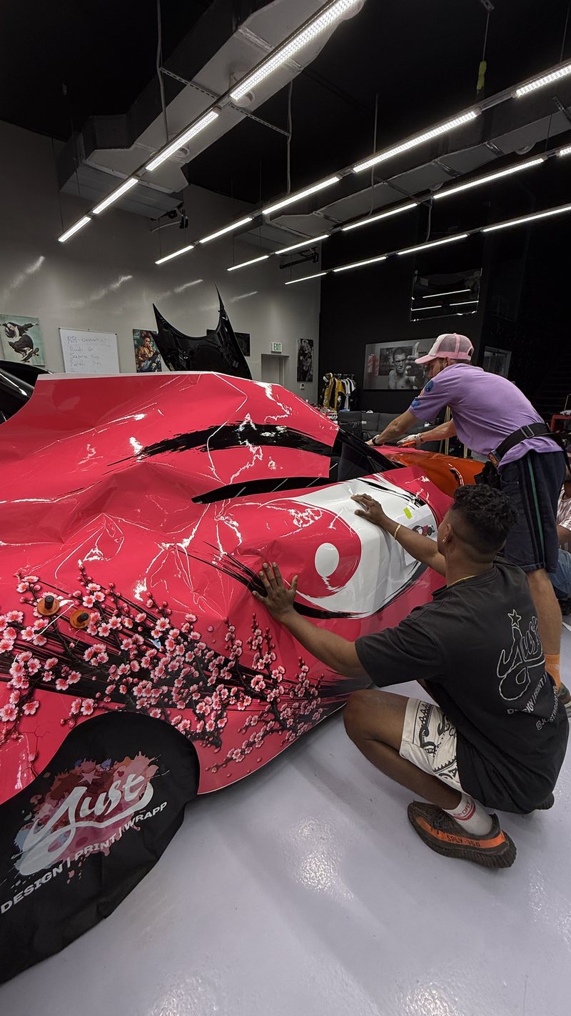 JUST GRAPHICS installers fitting the printed botanical wrap to the Toyota Supra