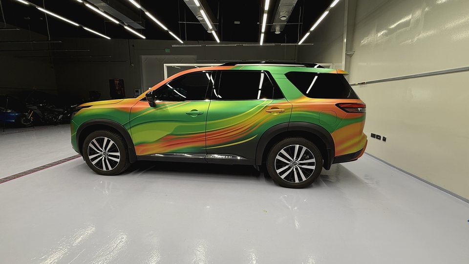 Bright green, orange and yellow custom printed SUV wrap completed in Dubai
