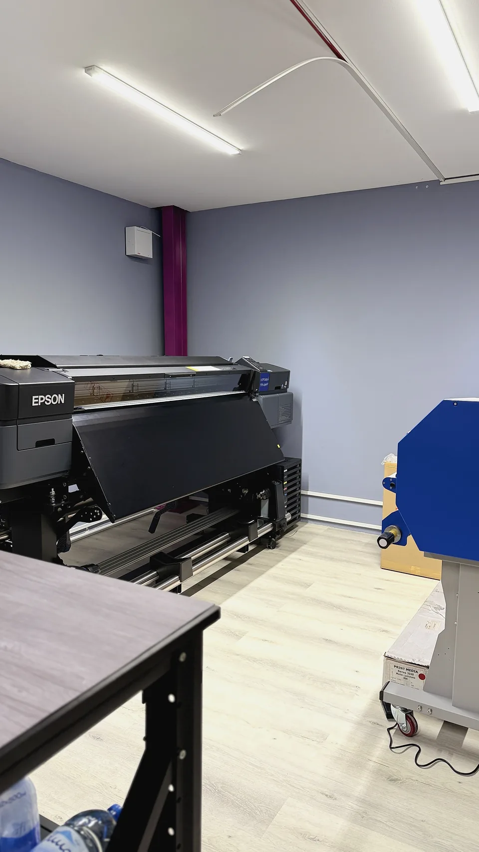 Epson large-format printer producing graphics inside the JUST GRAPHICS Dubai workshop