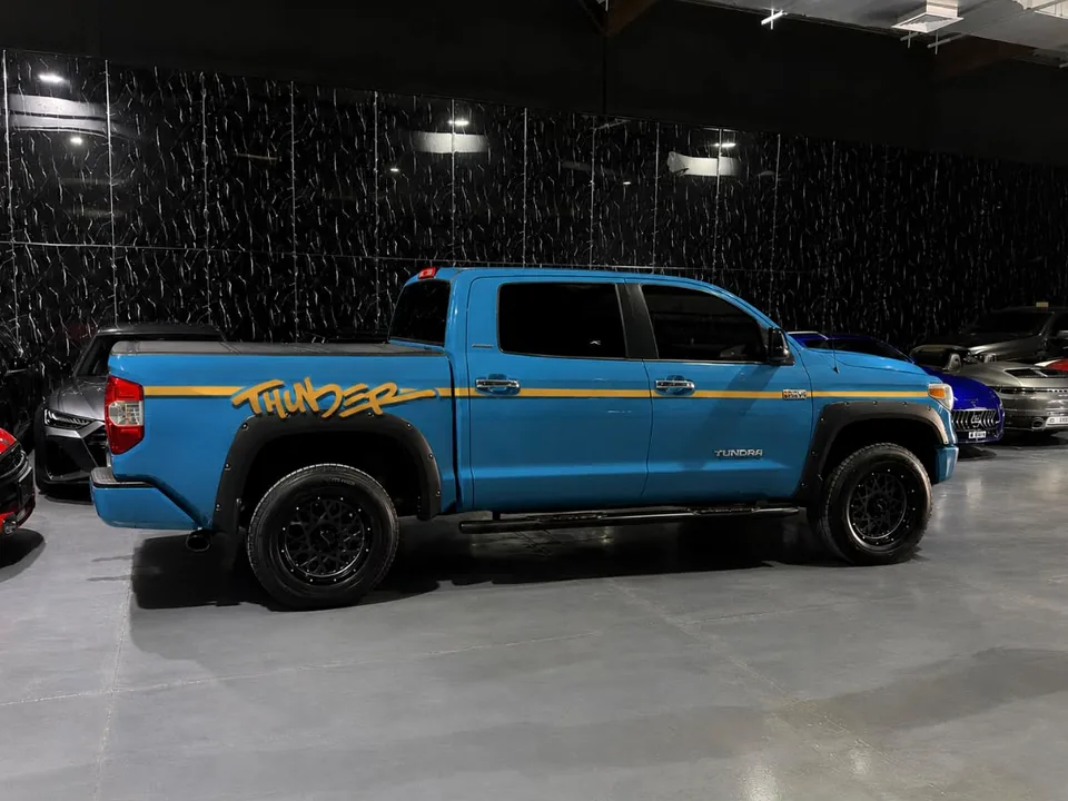 Blue pickup with an orange custom side decal completed by JUST GRAPHICS